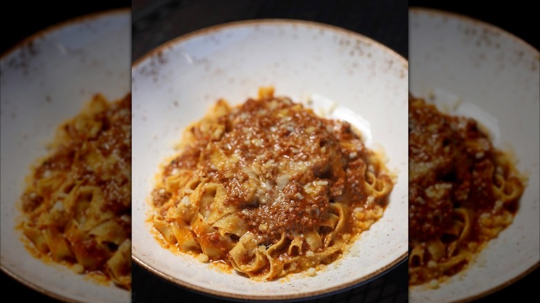 pasta in ragu sauce on a white plate
