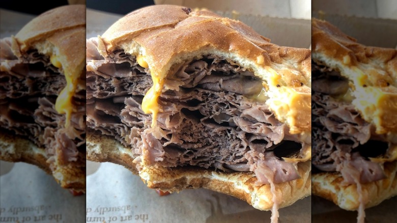 close up of a Half-Pound Roast Beef 'n Cheddar from Arby's with a bite taken out of it