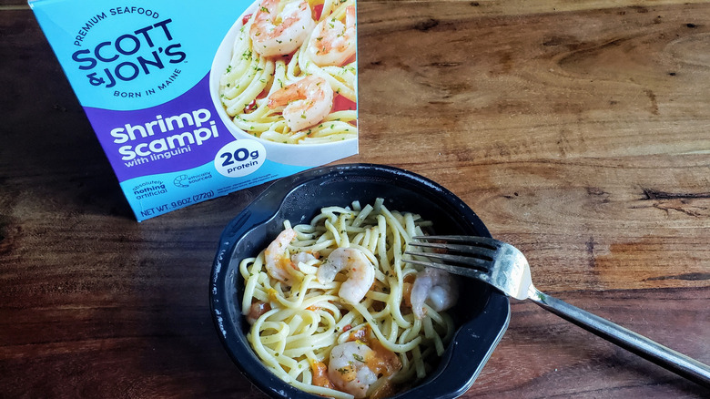 Bowl of Scott & Jon's Shrimp Scampi on wooden table with fork
