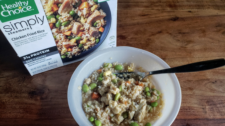 Bowl of Healthy Choice Simply Steamers Chicken Fried Rice on a wooden table