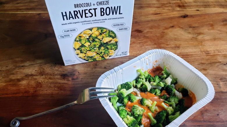 Daily Harvest Broccoli + Cheeze Harvest Bowl on a wooden table with fork