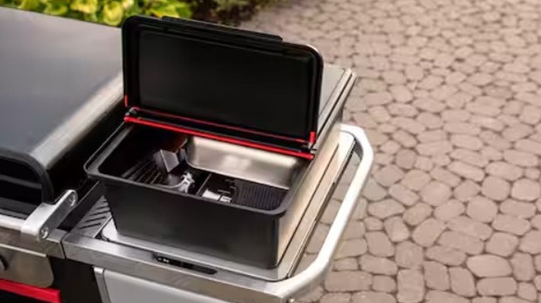 Weber Works Outdoor Storage Bin on the side of a grill
