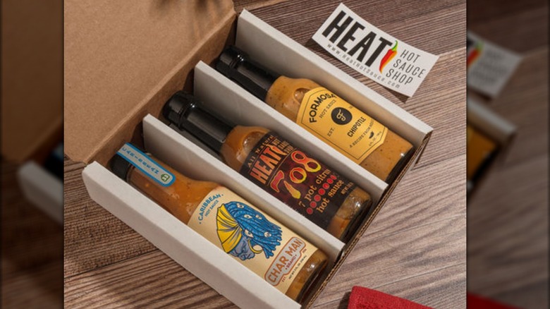 A gift box containing three bottles of hot sauce from Heat Hot Sauce Shop