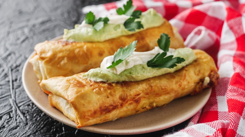 chimichanga on a plate on a table with red checked table cloth