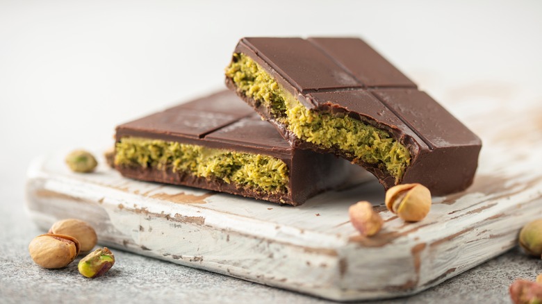 pieces of Dubai chocolate with pistachios on wooden board