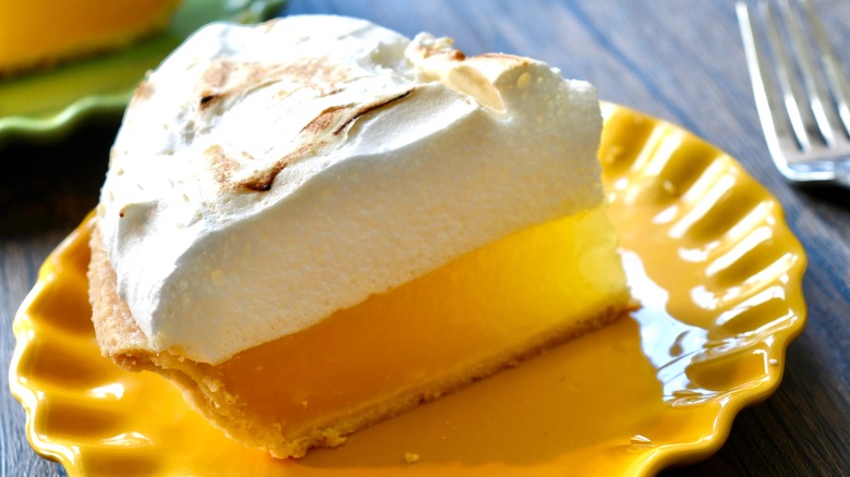 slice of Lemon meringue pie on yellow plate