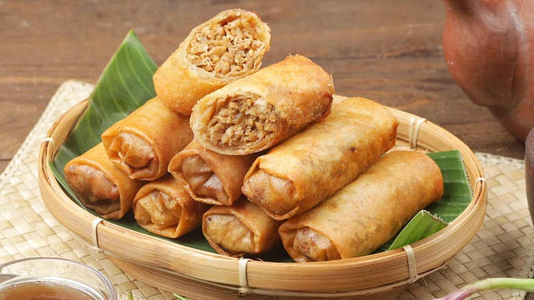 Pile of lumpia spring rolls in bamboo basket
