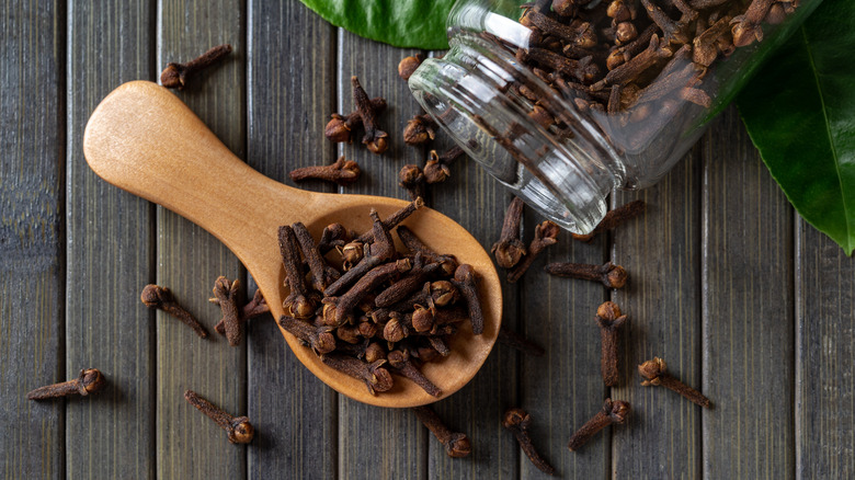 Whole cloves in wooden spoon