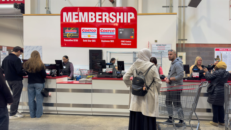 People waiting in line at the Costco membership desk