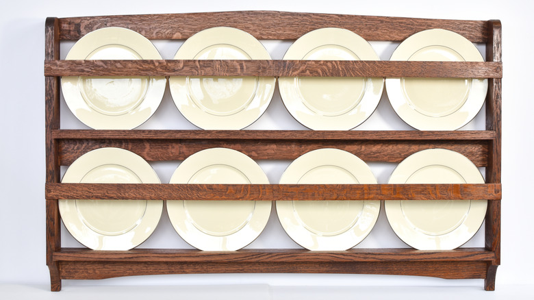 Antique oak plate rack with white china plates