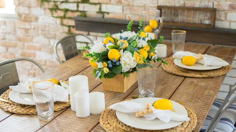 Summer kitchen table with lemons and a bright flower arrangement