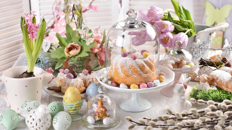 Themed Easter table with cake under glass cloche