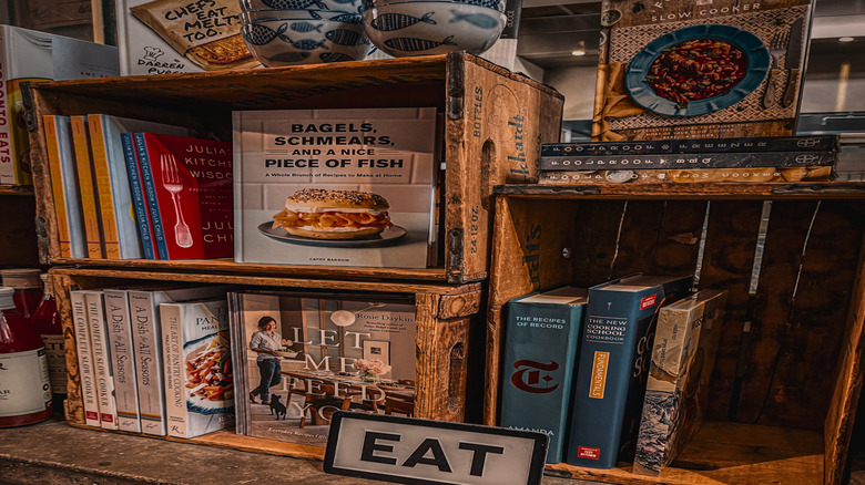 Several cookbooks stacked in wooden crates