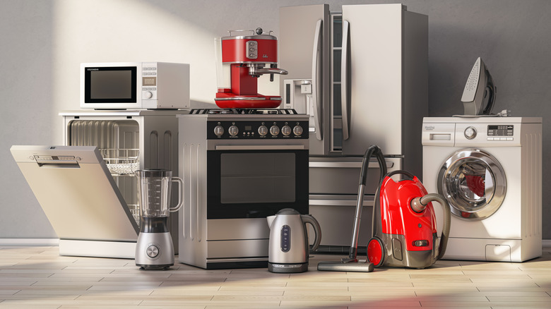 Kitchen appliances grouped together: dishwasher, oven, washing machine, vacuumn, kettle and blender