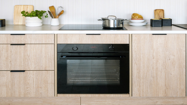 Minimalist white kitchen with coordinated range hood