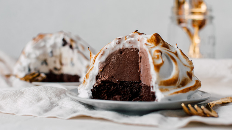 Baked Alaska on white plate with gold cutlery