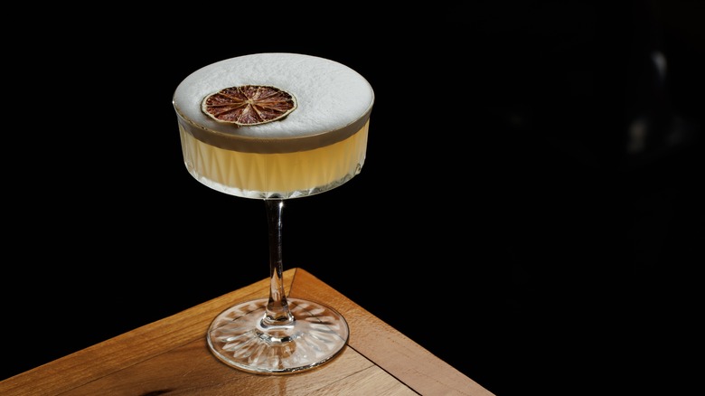 Coupe glass filled with yellow drink