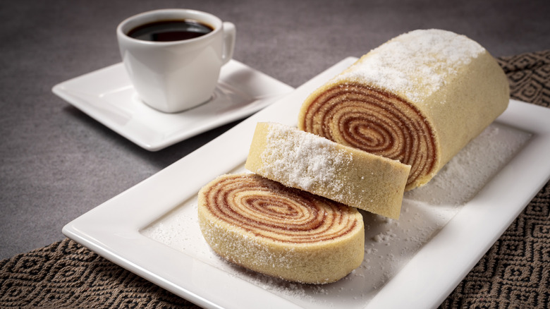 Sliced swiss roll on white rectangular plate
