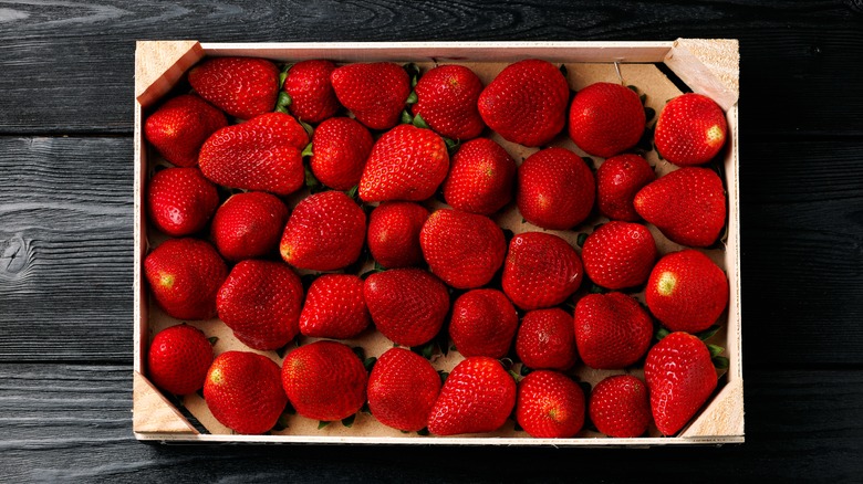 Fresh strawberries in wooden box
