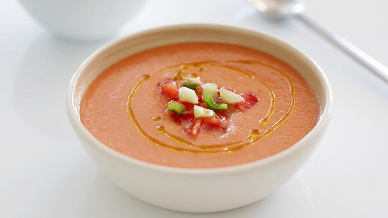 Gazpacho in a white bowl with garnish