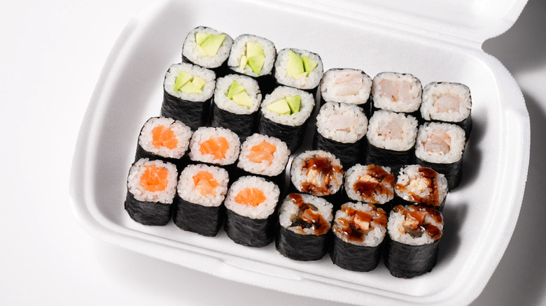 White container with rolls of sushi