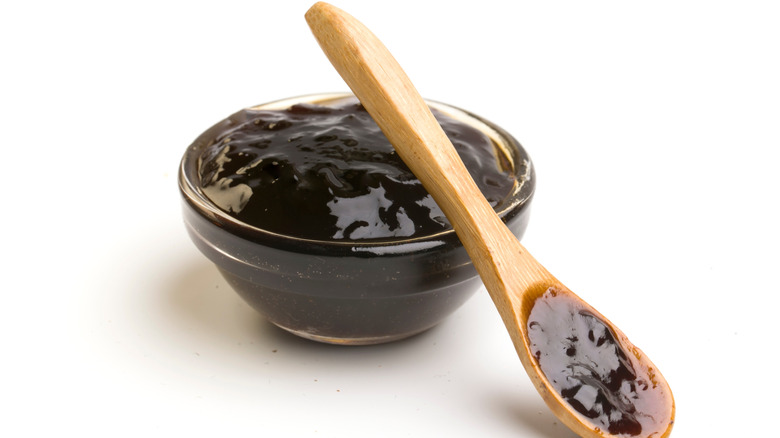 Bowl of teriyaki sauce with a wooden spoon