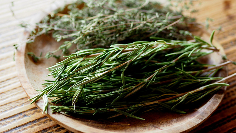 Bunches of dried rosemary and thyme on plate