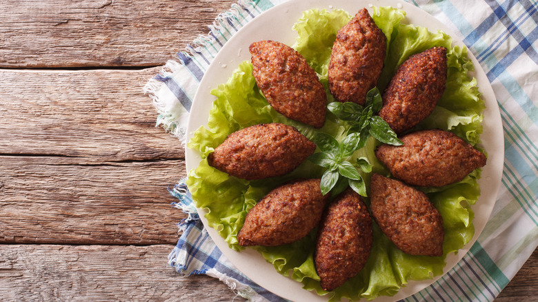 Kibbeh arranged on white plate