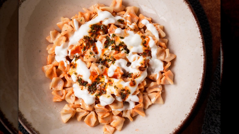 Bowl of manti with white sauce