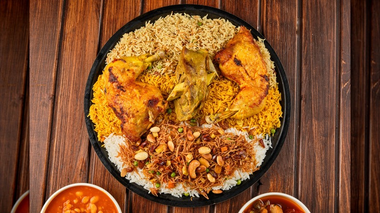 Quzi on black plate with various types of rice
