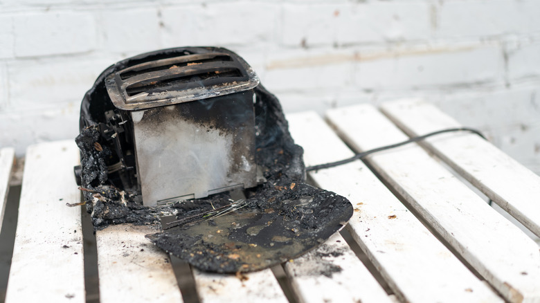 older model toaster, falling apart and half-melted after an electrical fire