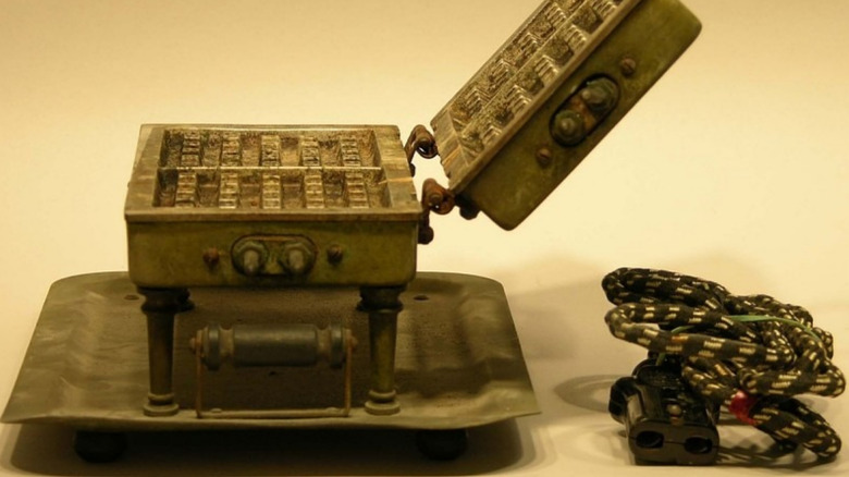 1920s vintage electric waffle iron, with its original fabric-covered power cord