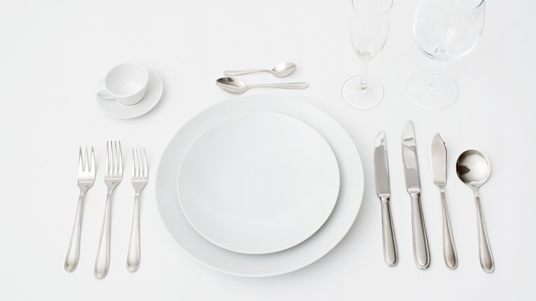 woman using a knife and fork to cut steak