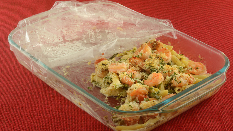 Leftover shrimp dish covered with plastic wrap