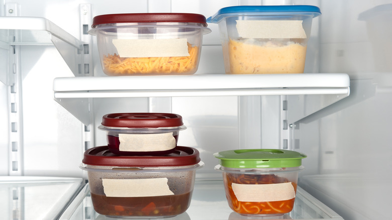 Plastic containers of leftovers, with freezer tape to write date