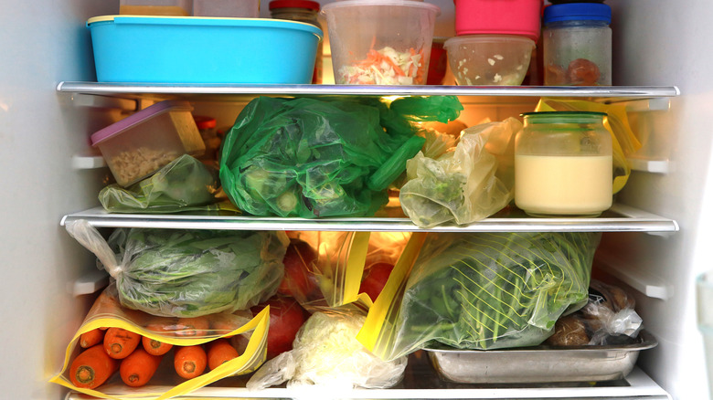 Fridge shelves packed with food