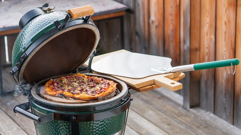 Pizza cooking on outdoor grill
