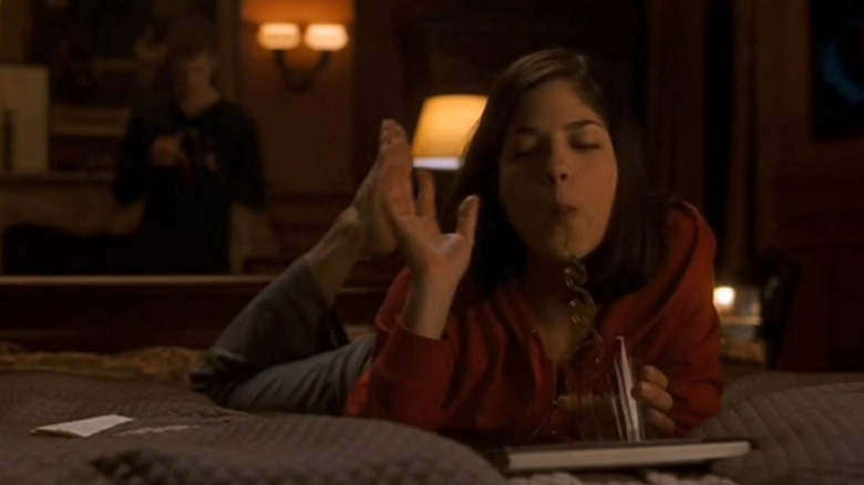 Cecile Caldwell lying on a bed drinking a long island iced tea in Cruel Intentions