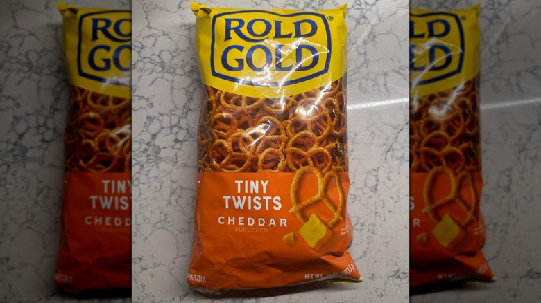 A bag of Rold Gold Tiny Twists Cheddar Flavored on a kitchen table