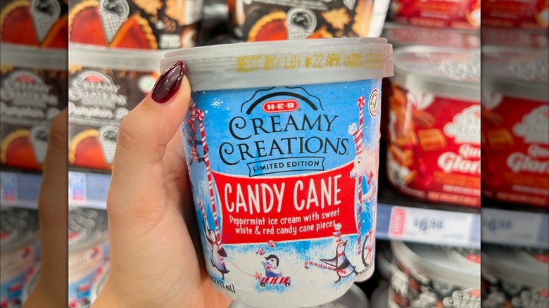 Hand holding a tub of Creamy Creations candy cane ice cream