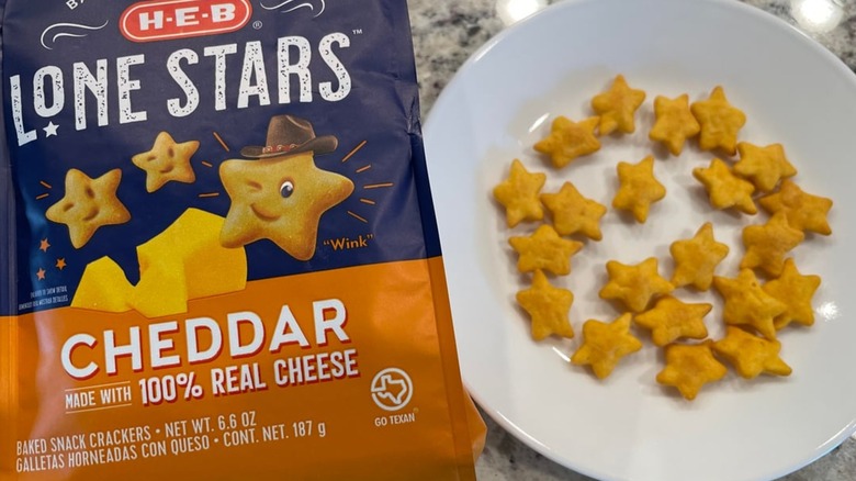 Packet of H-E-B cheddar Lone Stars next to a plate of crackers