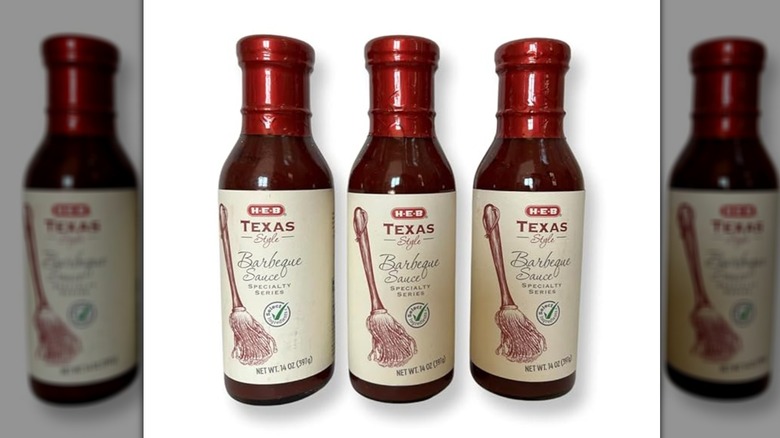 Three bottles of H-E-B Texas-style barbecue sauce on a white background