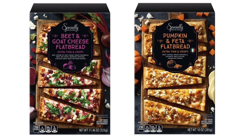 Boxes of Aldi Mama Cozzi's Pizza Kitchen flatbreads in Pumpkin Feta and Beet Root Goat Cheese on white background