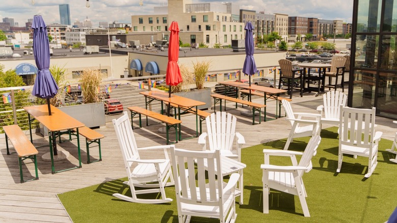 Tables and chairs on the rooftop beer garden on a sunny day