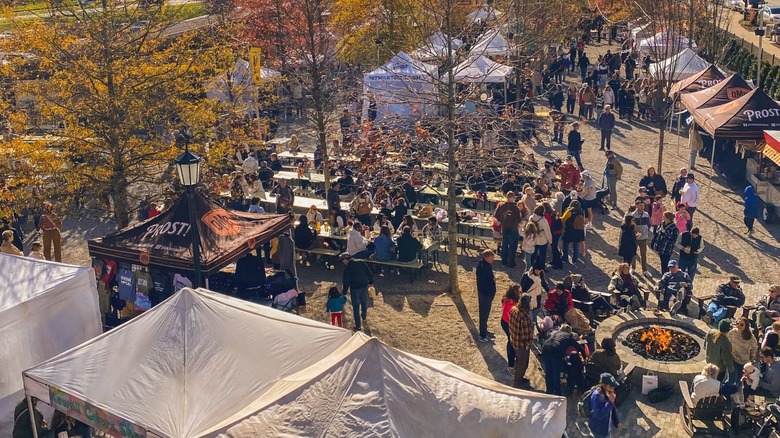 Aerial view of The Olde Mecklenburg Brewery with tents, a fire pit, and tables