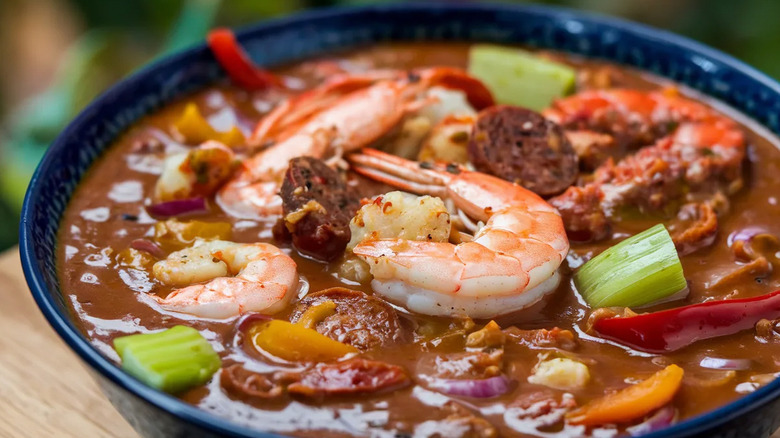 A close-up of Cajun shrimp gumbo in a blue bowl