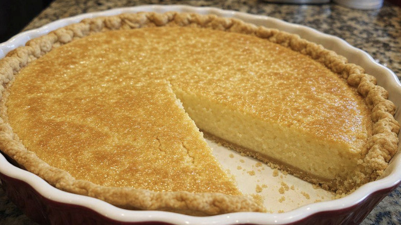 Southern chess pie in pan with a piece removed