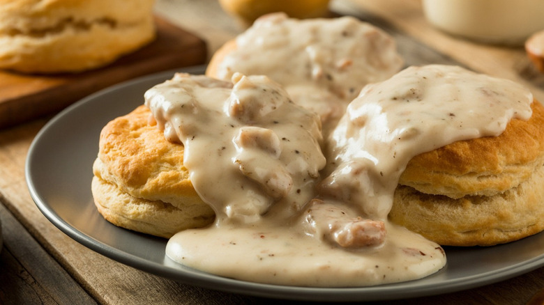 Southern biscuits with sausage gravy on a grey plate