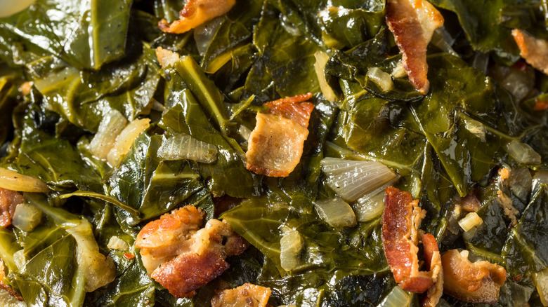 A close-up of cooked turnip greens with bacon and onions