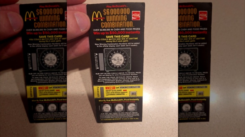 hand holding The $6 million winning combination game ticket, mirrored image